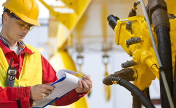 Engineer Checking Hydraulic Hose