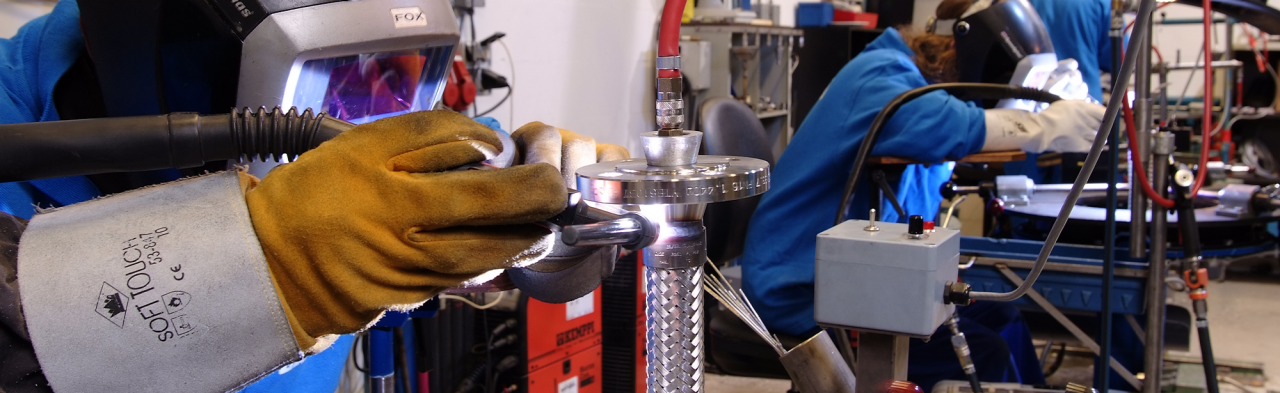 Industrial hose being built in a warehouse setting