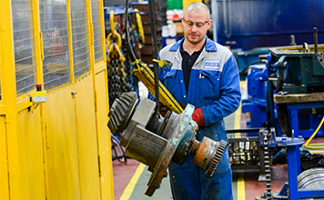 Engineer moving gearbox with overhead crane